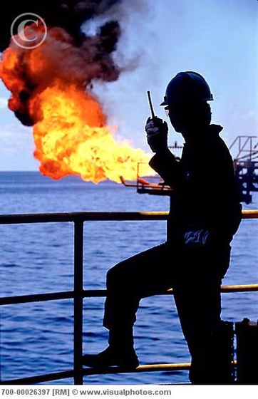 worker using walkie talkie at offshore oil 700-00026397