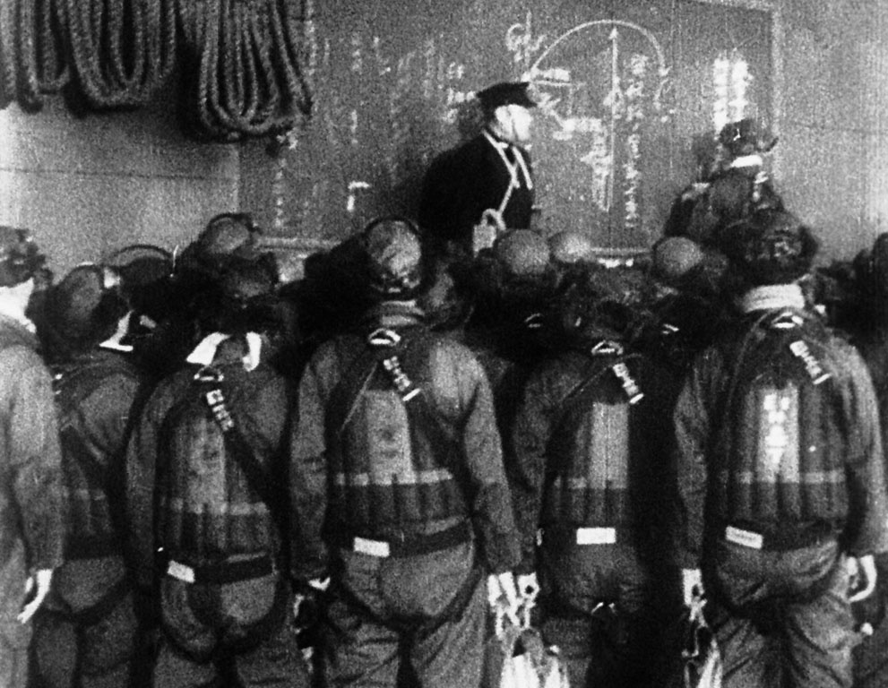 Japanese pilots get instructions aboard an aircraft carrier befo