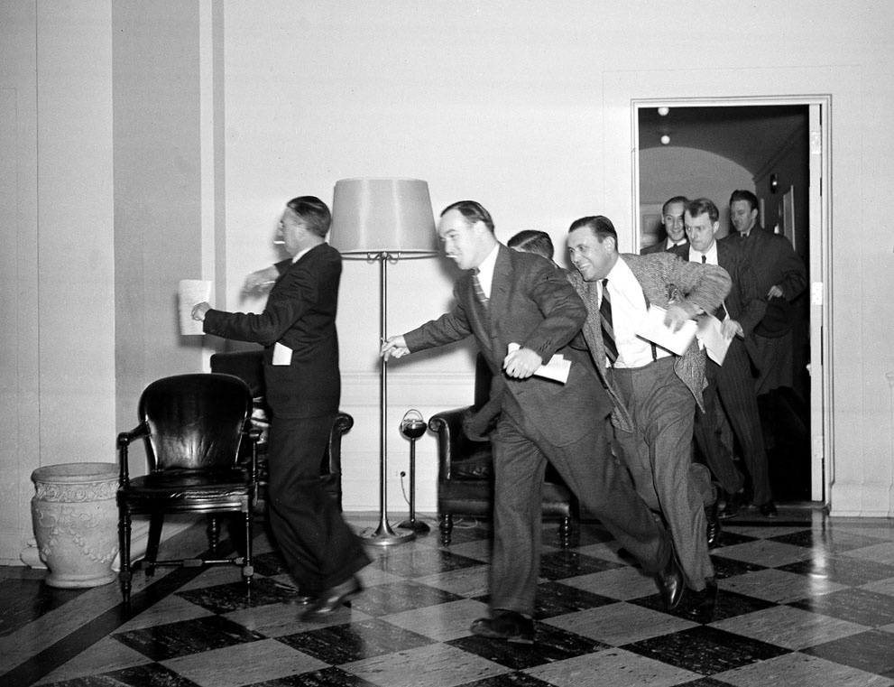 White House reporters dash for the telephones on December 7, 194