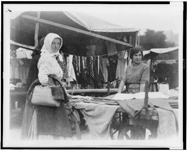 Woman shopping for textiles at market, Hungary 1923