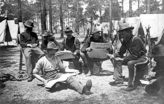 Company E of the 9th Infantry reading newspapers during the Span