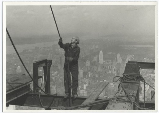 Construction-worker-standing-on-an-I-beam-pulling-a-rope-1931-52