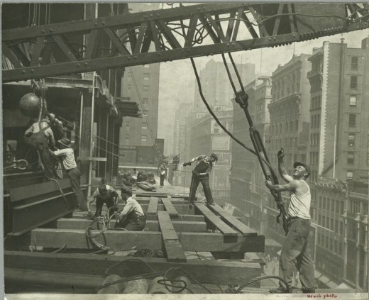 Workers-guiding-hoisting-cable-1931-520x423