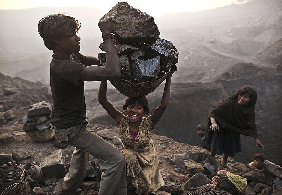 a-young-woman-trips-as-she-carries-a-large-basket-illegally-mine