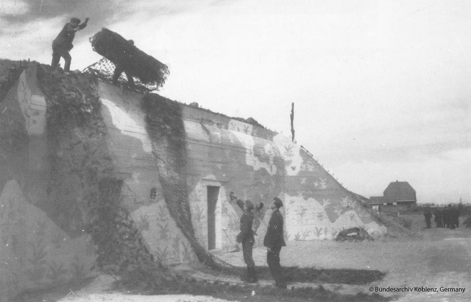 German soldiers camouflaging a German bunker near Zoutelande. Pi