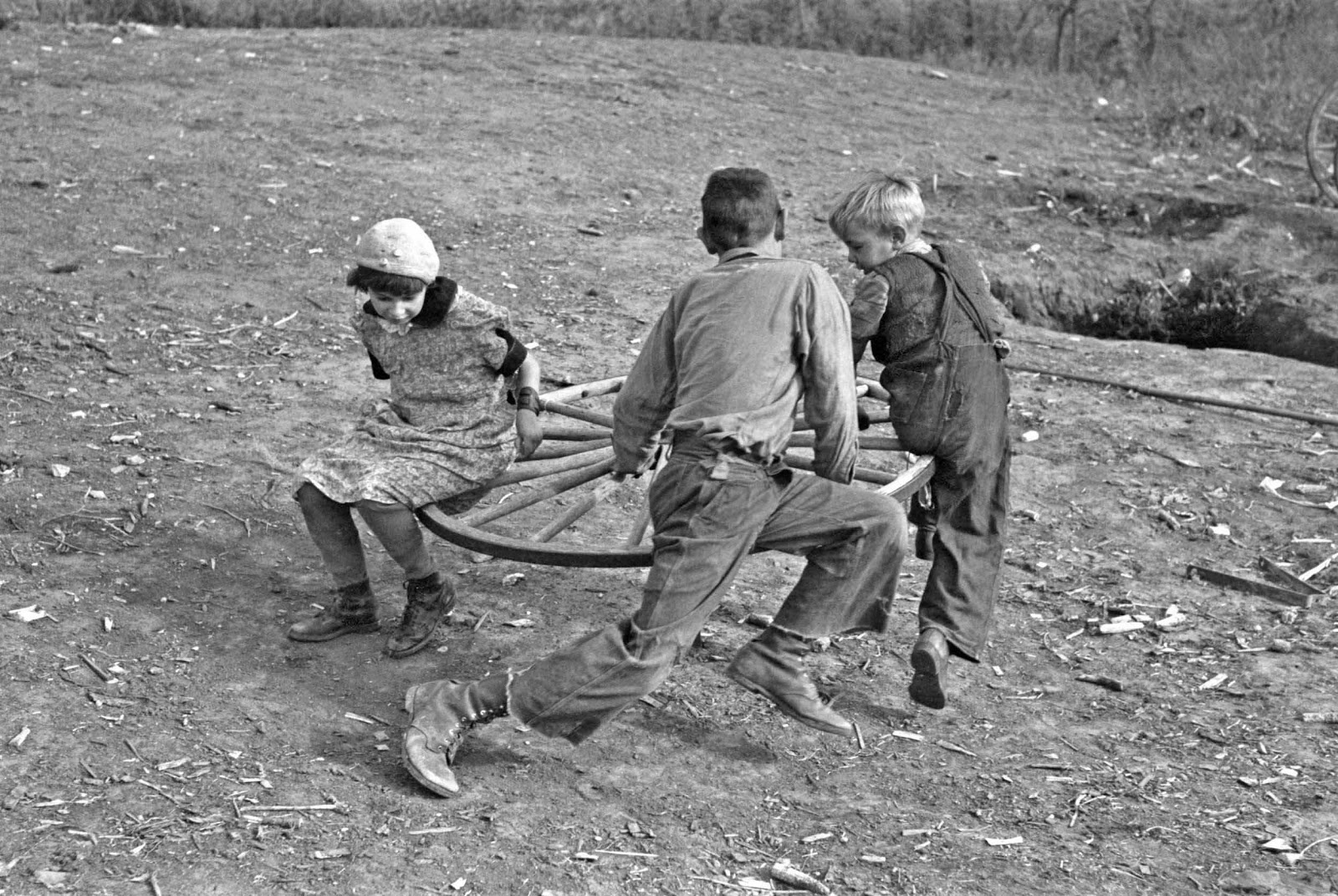 Russell Lee - Farm children playing on homemade merry-go-round. 